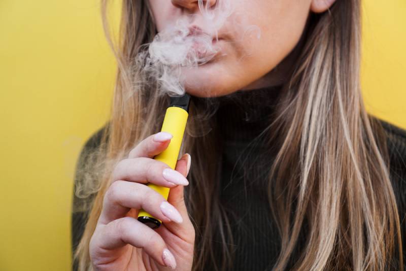 a young woman vaping